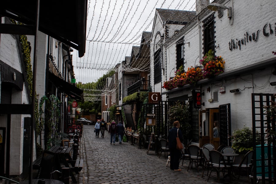 Cobblestone street with shops on either side