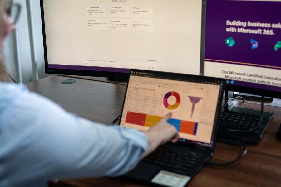 AI-5-1200x800 Woman working on two screens