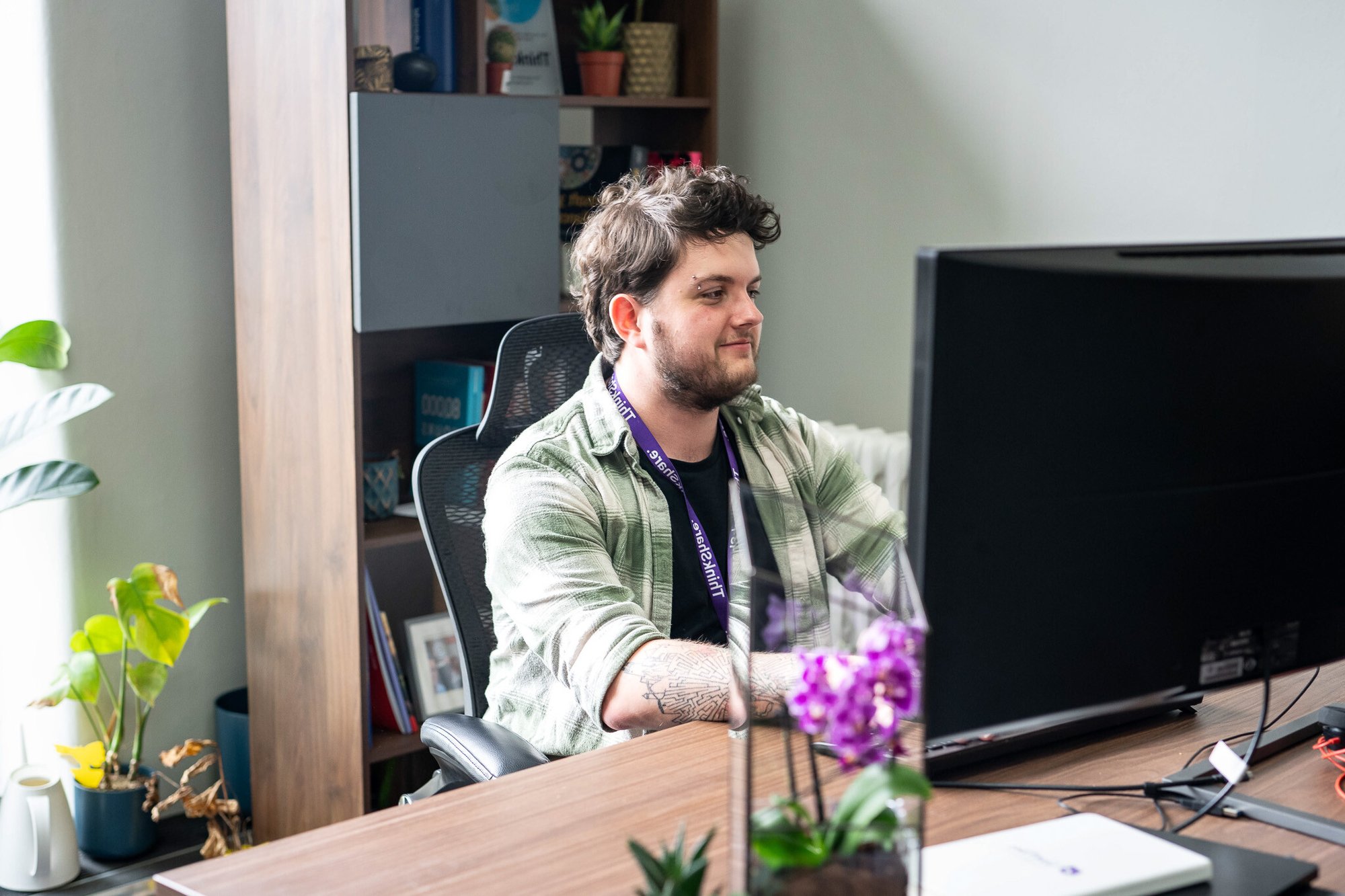 Individual sitting at a desk using a computer