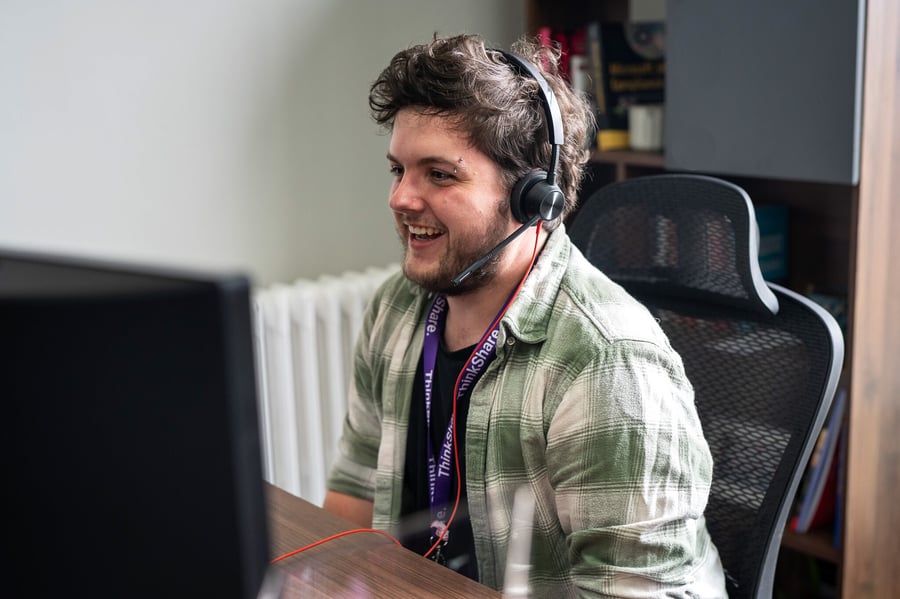 Individual sitting at a desk using a computer