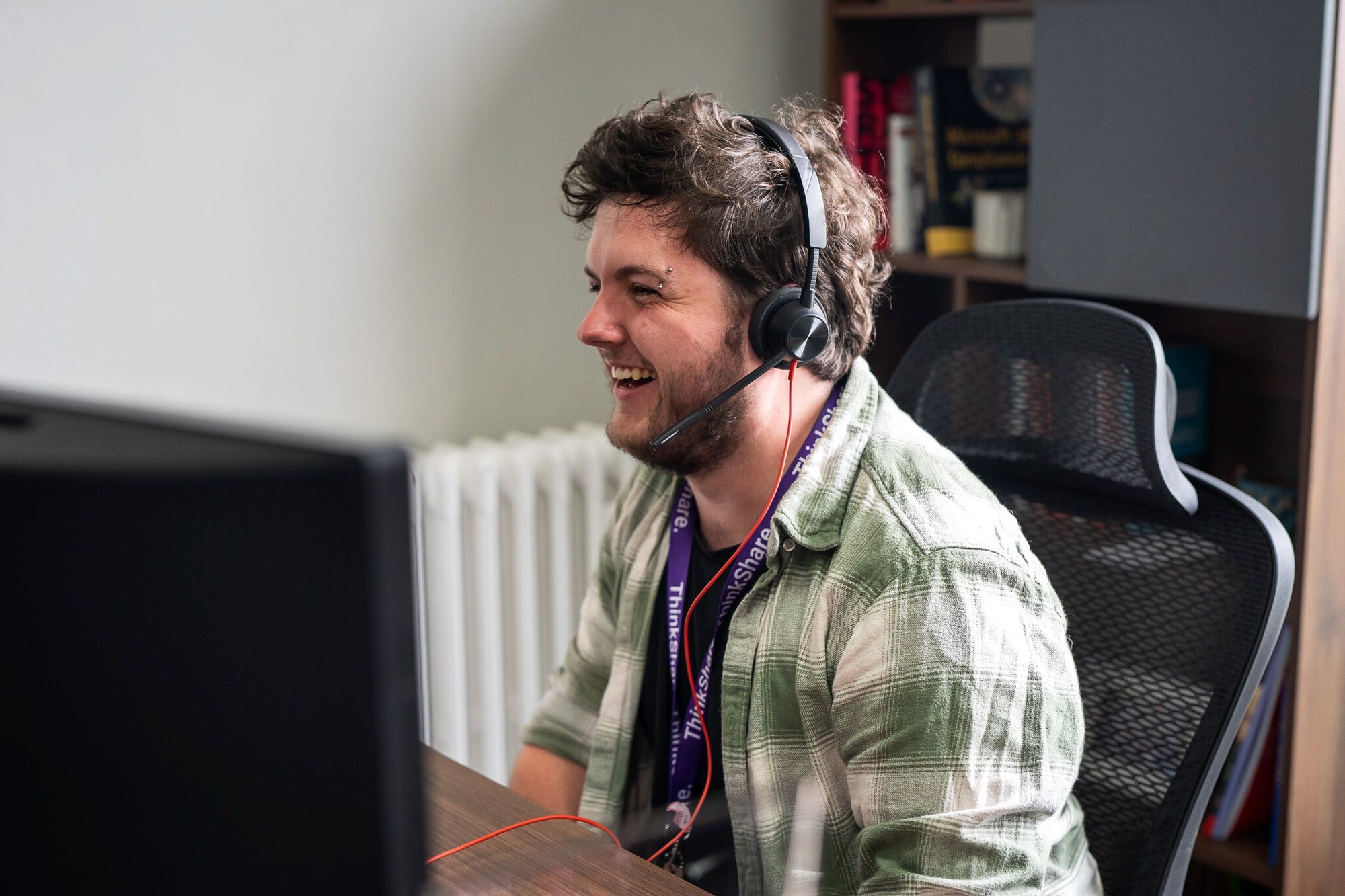 Individual sitting at a desk using a computer