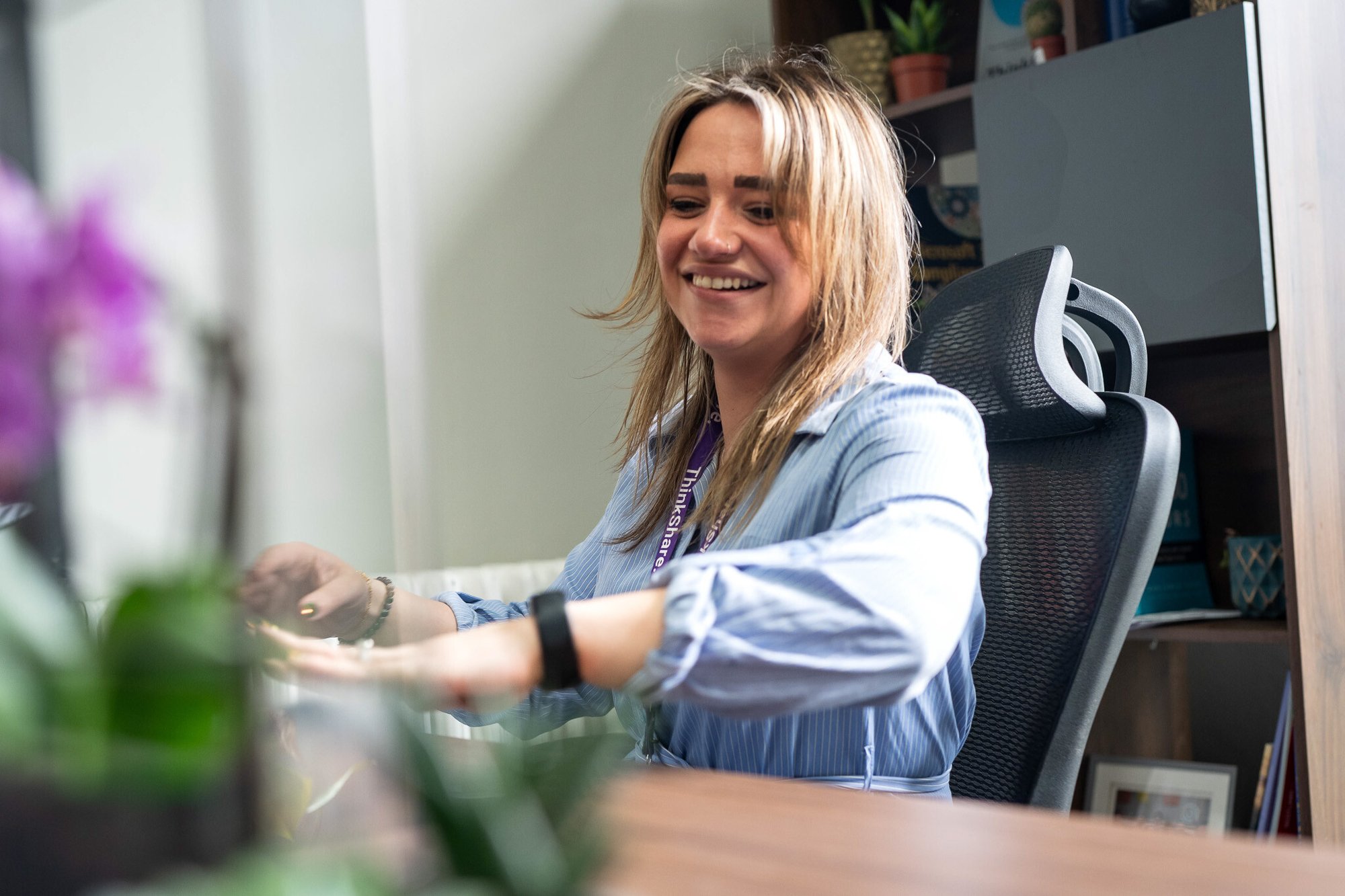 Woman sitting at a desk infront of a computer