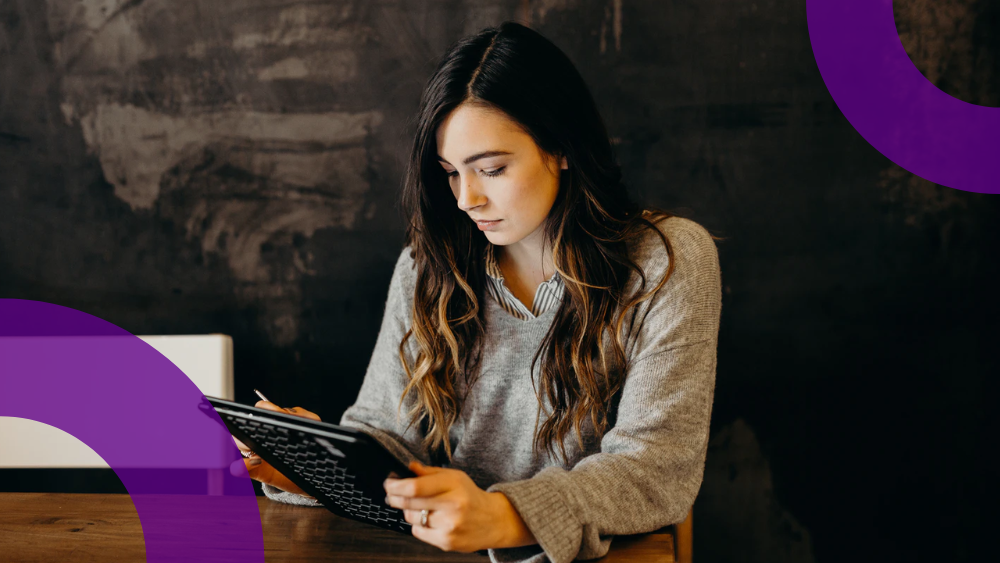 Woman using Dynamics 365 on a Surface computer in a cafe