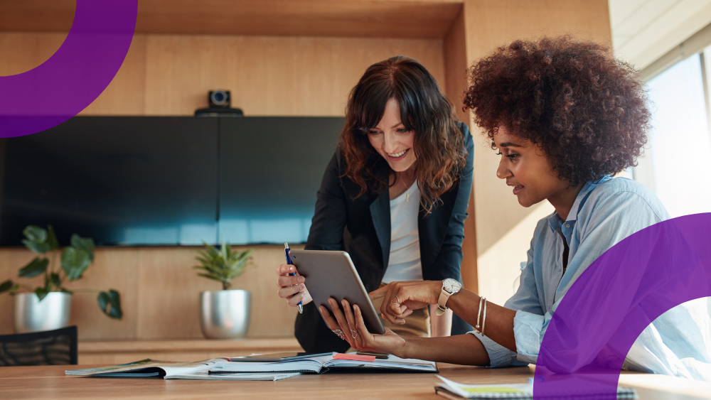 Two women in an office using Copilot to work more efficiently. 